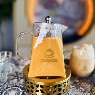 a pitcher of tea on a table