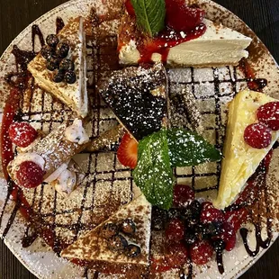 Dessert platter with tiramisu, cheesecake, cannoli, and berry tart