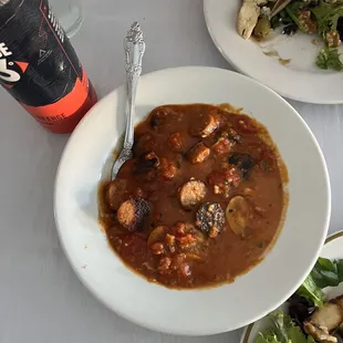 a bowl of soup and a plate of salad