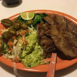 Carne Asada with a salad and spinach as a side. Just look at all that guacamole, which is my love language.
