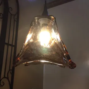 a glass shade hanging from the ceiling