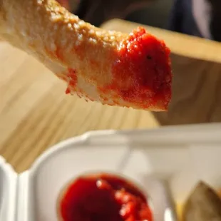 a hand holding a piece of bread