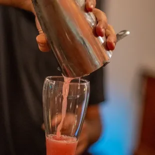 a bartender pouring a drink