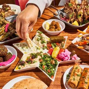 Falafel Mezza Sampler. Baba Ghannoush, Hummus, dolma. Tzatziki, Arabic Salad, Tabbouleh, 6 pieces of falafel and 2 pieces of fresh Pita