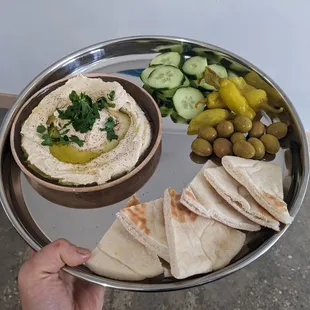 a person holding a plate of food