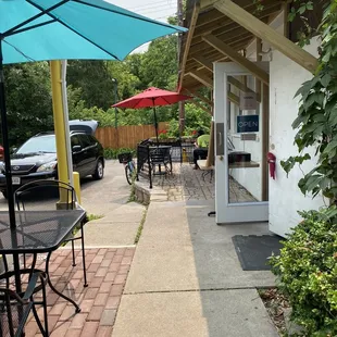a patio area with tables and umbrellas