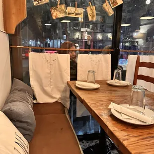 a woman sitting at a table in a restaurant