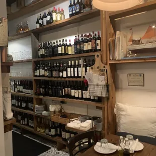 a table and shelves of wine