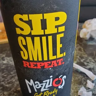 a cup of coffee with a smile on it