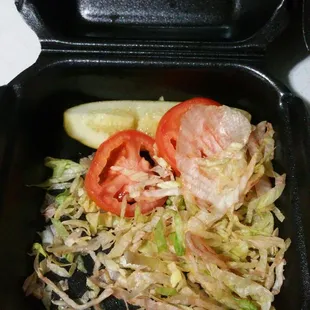 a salad in a styrofoam container