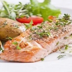 a plate of salmon and potatoes