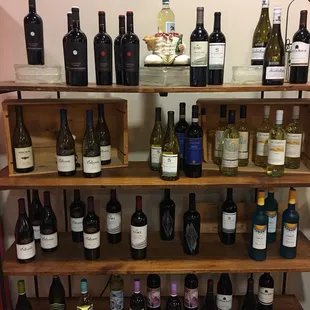 a shelf full of wine bottles