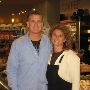 a man and a woman standing in front of a counter