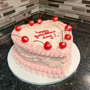 a birthday cake with cherries on top