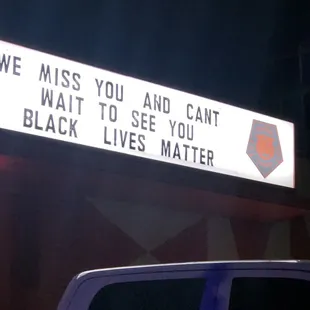 Sign behind the truck. Paper Tiger knows #BlackLivesMatter