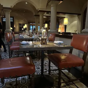 a dining area with a table and chairs