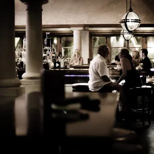 a man and a woman sitting at a bar