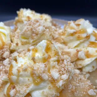 "Banana Creme Panipopo" Freshly made banana bread baked in a dreamy coconut sauce.  Topped w/Nilla crumbles, caramel &amp; banana whipped cream