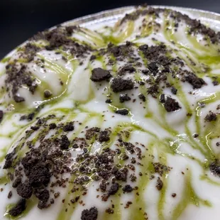 "Green Tea Panipopo" Freshly made grn tea bread, baked in a dreamy coconut sauce.  Topped w/grn tea drizzle and oreo