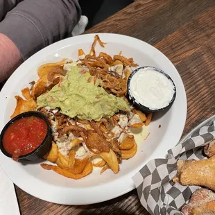 a plate of nachos with guacamole