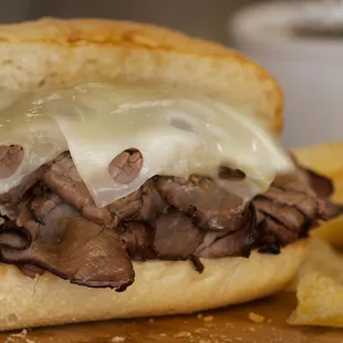 a beef sandwich with cheese and onions