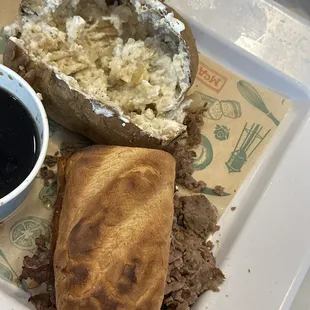 Burned, hard French dip sandwich with baked potato that was not tasty either