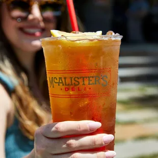 a woman holding a drink