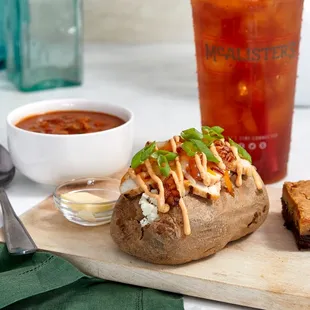 a baked potato on a cutting board