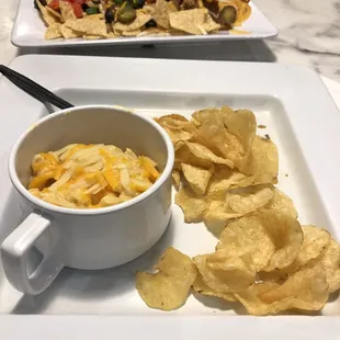 Kid portion of macaroni &amp; cheese. Loaded nachos in back.