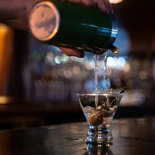 a bartender pouring a drink