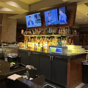 a bar with tvs on the wall