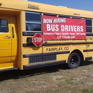 a yellow bus parked in a field