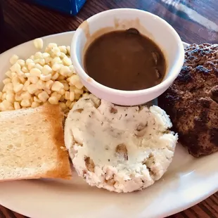 Salisbury steak mashed potatoes corn and mushrooms gravy on the side. Ugly but delicious!