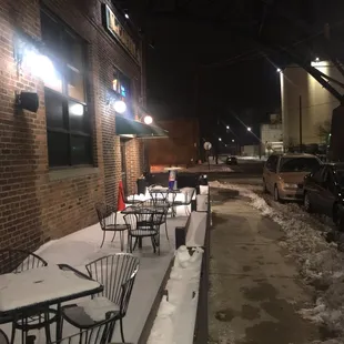 tables and chairs in the snow