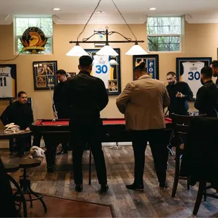 a group of men playing pool