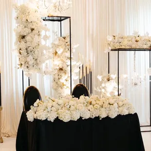 a black table with white flowers