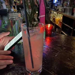a person using a cell phone at a bar
