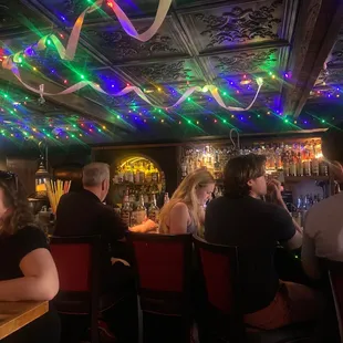 a group of people sitting at a bar