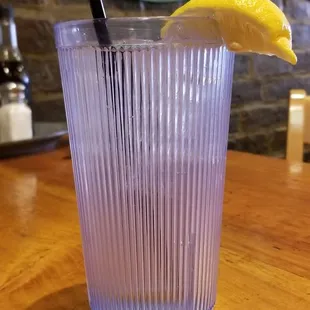 a glass with a lemon wedge