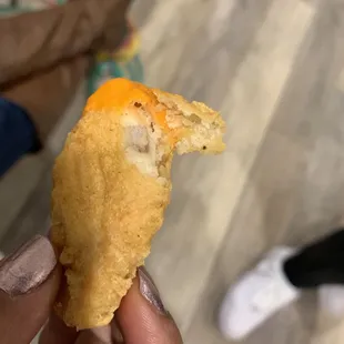 a person holding a piece of food