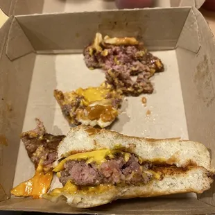 a half eaten burger and a half eaten sandwich