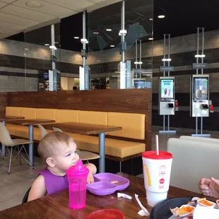 a woman and a baby eating at a table