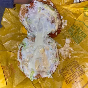 a half eaten sandwich with cheese and lettuce