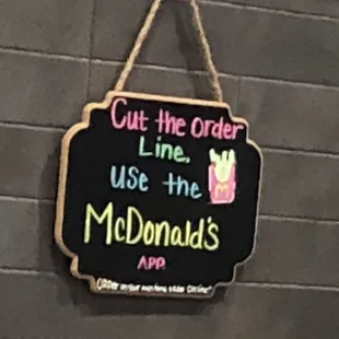 a sign hanging on a brick wall