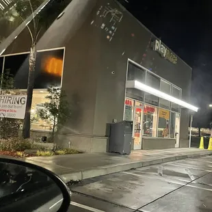 a view of the outside of a restaurant at night