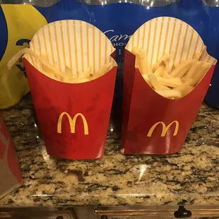 fries in red paper bags on a counter