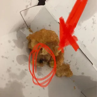 a half eaten donut with a red marker