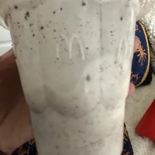 a hand holding a cup of coffee