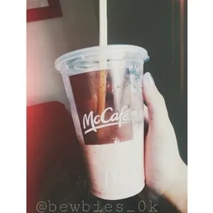 a hand holding a cup of coffee