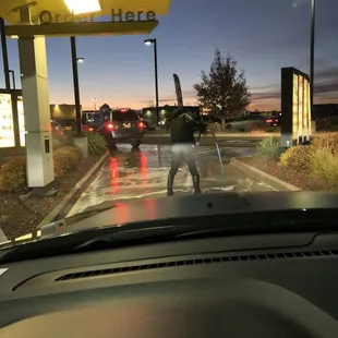 a man walking his dog in the rain